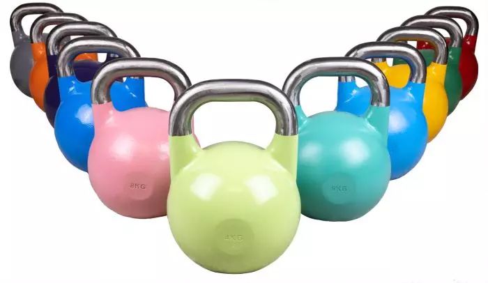 Elva stycken kettlebells i en mängd olika färger och vikter